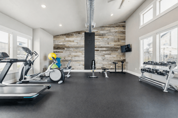 Fitness center with wood accent wall